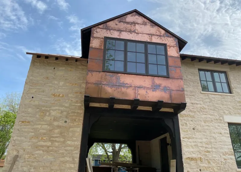 Copper metal panel facade on a stone building for Metal Roof Coating in Bear